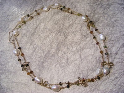 36" long solid gold chain,
with natural tourmaline beads, and natural baroque white pearls, chain, and hook clasp.