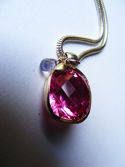 Huge, bold, natural fushia pink topaz, cushion-cut, wrapped in gold with natural sapphire briolette droplet, on silver slinky chain