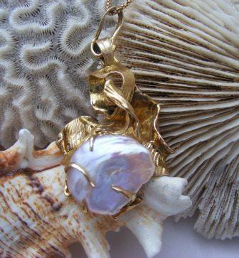 Huge Natural rare baroque Pearl in heavy 'crashing waves' gold pendant setting